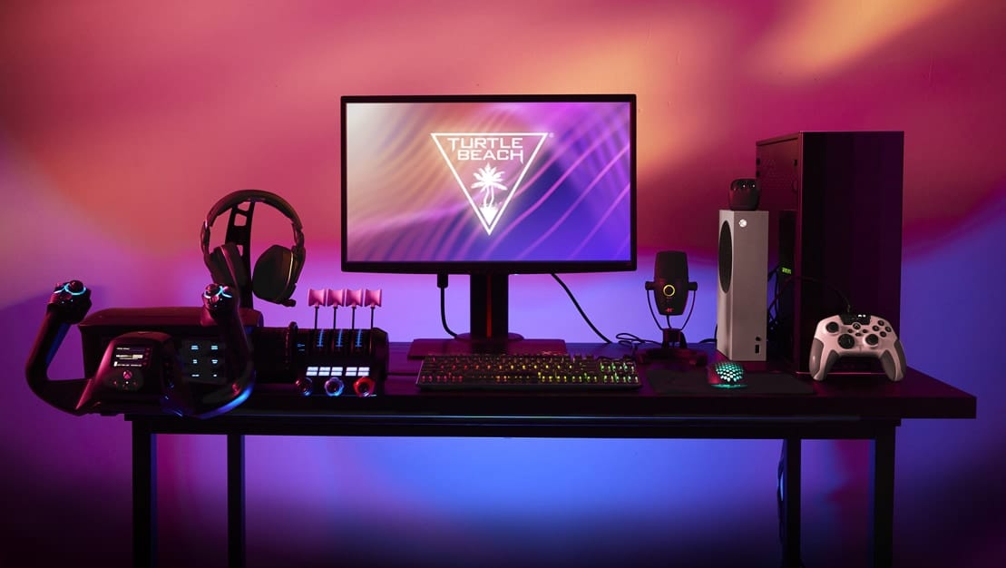 Image of a PC with a Turtle Beach logo on the monitor and the company's headsets, keyboard, flight stick etc. connected