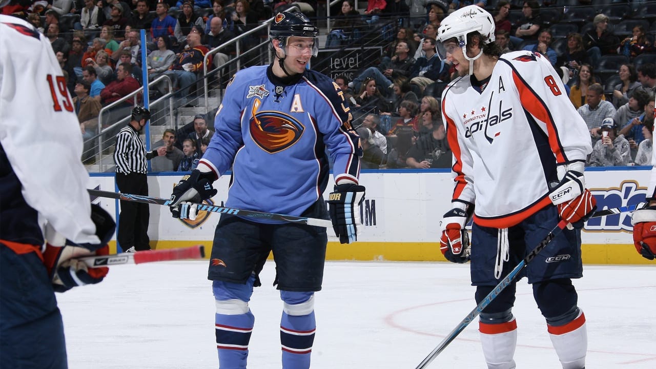 Ilya Kovalchuk and Alex Ovechkin chat between plays in a 2008 Thrashers-Capitals game. The Thrashers jersey has a stripe on the left arm but not the right.