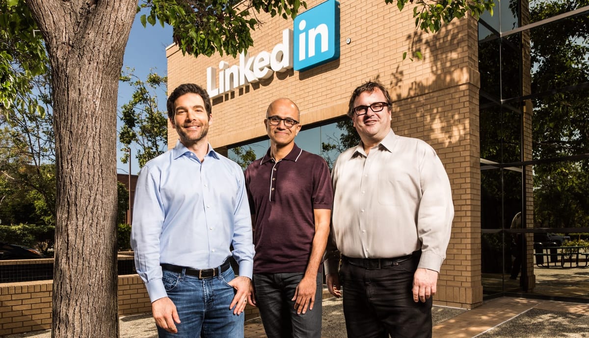 Image of LinkedIn HQ with the company's bigwigs and Microsoft CEO Satya Nadella standing and smiling